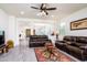 Open living room with tile floors, a ceiling fan, and comfortable seating at 21150 N Evergreen Dr, Maricopa, AZ 85138
