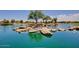 Scenic pond view featuring rock formations and lush landscaping in a serene community setting at 21150 N Evergreen Dr, Maricopa, AZ 85138