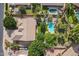 Overhead view of backyard with swimming pool, manicured lawn, and mature trees surrounding the property at 2160 E Kenwood St, Mesa, AZ 85213