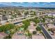 Expansive aerial shot showcasing the neighborhood, canal, and distant mountain views on a sunny day at 2160 E Kenwood St, Mesa, AZ 85213