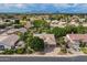 Aerial view showcasing a home with a pool, lush landscaping, and a mountain backdrop in the distance at 2160 E Kenwood St, Mesa, AZ 85213
