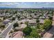 Panoramic aerial of a residential area featuring mature trees, pools, and mountain views at 2160 E Kenwood St, Mesa, AZ 85213