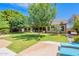Spacious backyard featuring lush lawn, mature trees, and a patio, offering ample space for recreation and relaxation at 2160 E Kenwood St, Mesa, AZ 85213