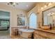 Luxurious bathroom boasts soaking tub, granite countertops and decorative tile backsplash at 2160 E Kenwood St, Mesa, AZ 85213