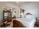 Comfortable bedroom featuring a classic wood bed frame, matching furniture, and mirrored closet doors at 2160 E Kenwood St, Mesa, AZ 85213