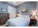 Inviting bedroom with cozy decor, light gray walls, and ample storage provided by a classic dresser at 2160 E Kenwood St, Mesa, AZ 85213