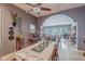 Formal dining room with a long table, a ceiling fan, and an archway at 2160 E Kenwood St, Mesa, AZ 85213