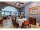 Elegant dining room featuring classic decor, a ceiling fan, and an open view into a spacious living area at 2160 E Kenwood St, Mesa, AZ 85213
