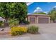 Home featuring a well-maintained front yard with a mature tree and a two-car garage at 2160 E Kenwood St, Mesa, AZ 85213
