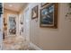 Well-lit hallway featuring decorative tile flooring and wall decor at 2160 E Kenwood St, Mesa, AZ 85213