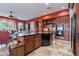 Well-equipped kitchen with a central island, wooden cabinets, and built-in appliances at 2160 E Kenwood St, Mesa, AZ 85213
