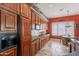 Kitchen with wood cabinets, stone countertops and a full-sized refrigerator at 2160 E Kenwood St, Mesa, AZ 85213
