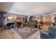 Inviting living room features a decorative rug, a grand piano and an elegant entrance door at 2160 E Kenwood St, Mesa, AZ 85213