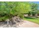 Cozy outdoor patio with comfortable seating and shaded by mature trees, creating a relaxing retreat at 2160 E Kenwood St, Mesa, AZ 85213