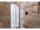 Walk-in shower features stone tiling and an arched entrance at 2160 E Kenwood St, Mesa, AZ 85213