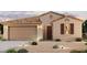 Exterior elevation of home with a large garage and manicured front yard at 22085 N Rummler Ln, Maricopa, AZ 85138