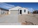 Charming single-story home featuring a desert-style gravel yard, a two-car garage and a welcoming arched entryway at 22085 N Rummler Ln, Maricopa, AZ 85138