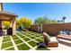 Backyard with artificial turf, patio area, built-in BBQ and lounge furniture at 2229 N 139Th Dr, Goodyear, AZ 85395