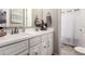 Bathroom featuring double sinks, a large mirror, and plenty of counter space at 2229 N 139Th Dr, Goodyear, AZ 85395