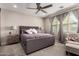 Serene bedroom with neutral tones, plush carpeting, a comfortable king-size bed, and plenty of natural light at 2229 N 139Th Dr, Goodyear, AZ 85395