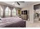 This bedroom features a ceiling fan, plush carpet, and a luxurious lavender comforter at 2229 N 139Th Dr, Goodyear, AZ 85395