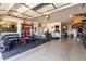Garage outfitted with workout equipment and weights, and epoxied floor at 2229 N 139Th Dr, Goodyear, AZ 85395