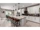 Gourmet kitchen with white cabinets, stainless steel appliances, granite countertops, and large center island with seating at 2229 N 139Th Dr, Goodyear, AZ 85395