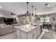 Open concept gourmet kitchen featuring large island with seating and stainless steel appliances open to the living room at 2229 N 139Th Dr, Goodyear, AZ 85395