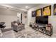 Cozy sitting area with comfortable grey chair, decorative rug, and a large television for movie nights at 2229 N 139Th Dr, Goodyear, AZ 85395