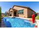 Backyard pool area featuring a basketball hoop, lush landscaping, and outdoor seating at 2229 N 139Th Dr, Goodyear, AZ 85395