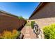 Side yard with a narrow pathway, low-maintenance landscaping, and gravel ground cover at 2229 N 139Th Dr, Goodyear, AZ 85395