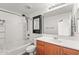 Bathroom with tub, shower, and vanity with wood cabinet at 2337 E Fraktur Rd, Phoenix, AZ 85040