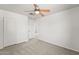 Bedroom features neutral carpet, white walls, ceiling fan, closet, and access way at 2337 E Fraktur Rd, Phoenix, AZ 85040