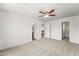 Spacious bedroom features neutral carpet, white walls, ceiling fan, and two entry ways at 2337 E Fraktur Rd, Phoenix, AZ 85040