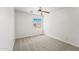 This bedroom features neutral carpet, white walls, ceiling fan, and a window at 2337 E Fraktur Rd, Phoenix, AZ 85040