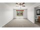 Spacious bedroom with neutral carpeting, a window, and en-suite bathroom access at 2337 E Fraktur Rd, Phoenix, AZ 85040
