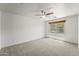 Bedroom with neutral carpet, white walls, ceiling fan, and a window at 2337 E Fraktur Rd, Phoenix, AZ 85040