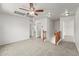Spacious bonus room with plush carpeting, ceiling fan, and natural wood railing at 2337 E Fraktur Rd, Phoenix, AZ 85040