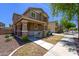 Two-story home featuring a covered porch with stone accents and manicured landscaping at 2337 E Fraktur Rd, Phoenix, AZ 85040