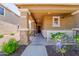 Inviting covered front porch with stone pillars and a view of the home's entry at 2337 E Fraktur Rd, Phoenix, AZ 85040