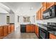 Bright, open kitchen boasts wood cabinets, black appliances, and granite countertops at 2337 E Fraktur Rd, Phoenix, AZ 85040