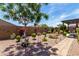 Beautiful landscaped backyard with decorative elements and manicured plants, providing a serene outdoor retreat at 23707 W Hess Ave, Buckeye, AZ 85326