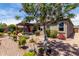 Serene backyard featuring a pergola, garden landscaping, and decorative art, creating a tranquil outdoor space at 23707 W Hess Ave, Buckeye, AZ 85326