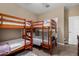 Cozy bedroom featuring two wooden bunk beds, perfect for a shared ' room or accommodating guests at 23707 W Hess Ave, Buckeye, AZ 85326