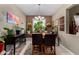 Dining room with tile flooring, elegant chandelier, and bright window at 23707 W Hess Ave, Buckeye, AZ 85326