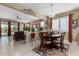 Bright dining area featuring a chandelier, wood table, and natural light flowing through the window at 23707 W Hess Ave, Buckeye, AZ 85326