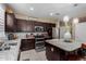 Well-equipped kitchen with granite countertops, stainless appliances, a tile backsplash, and a center island at 23707 W Hess Ave, Buckeye, AZ 85326