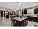 Spacious kitchen featuring a central island, granite countertops, and open layout connected to the living area at 23707 W Hess Ave, Buckeye, AZ 85326