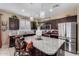 Modern kitchen with granite countertops, stainless steel appliances, and a center island with barstool seating at 23707 W Hess Ave, Buckeye, AZ 85326