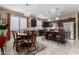Eat-in kitchen showcasing dark wood cabinets, stainless steel appliances, and a central island with barstool seating at 23707 W Hess Ave, Buckeye, AZ 85326